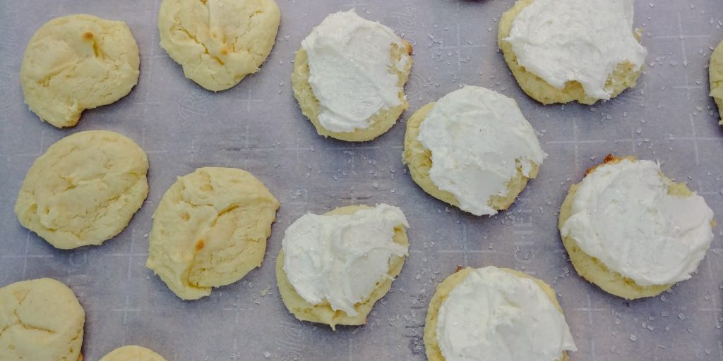 Wedding Cake Cookies complete on parchment partially frosted