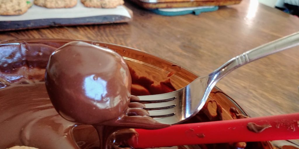 The Best Peanut Butter BonBons dipping bonbons on fork