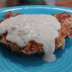 Turpin Breaded Pork chops complete on plate with gravy 1